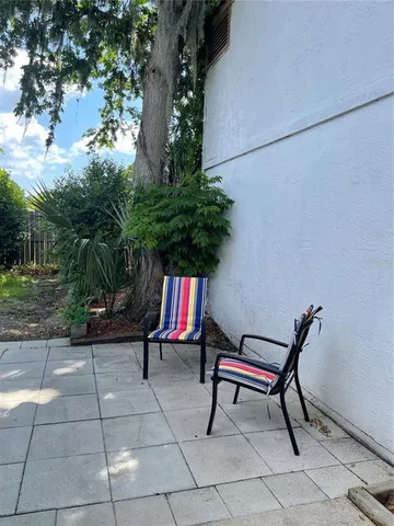 a view of outdoor space with lots of furniture and plants