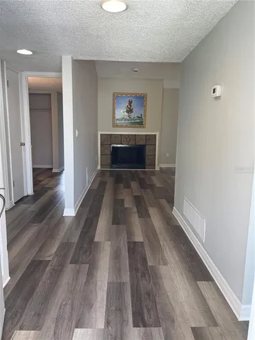 wooden floor in an empty room with a fireplace