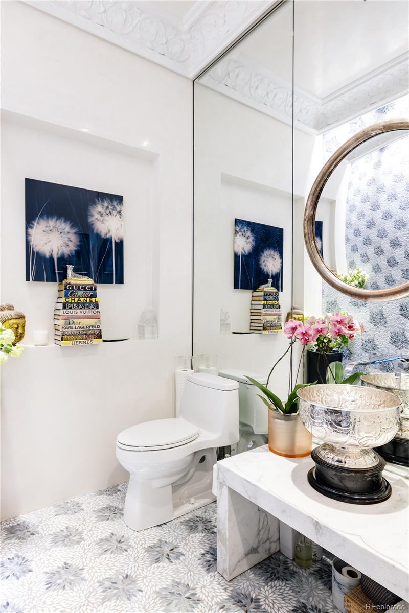 469 Cook Street Denver, CO 80206 - Photo 11 of 50 a bathroom with a toilet a sink and a mirror