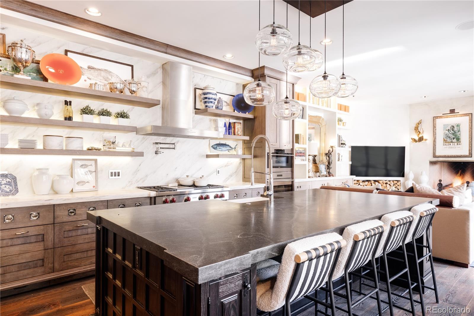 469 Cook Street Denver, CO 80206 - Photo 13 of 50 a kitchen with a table chairs and a chandelier