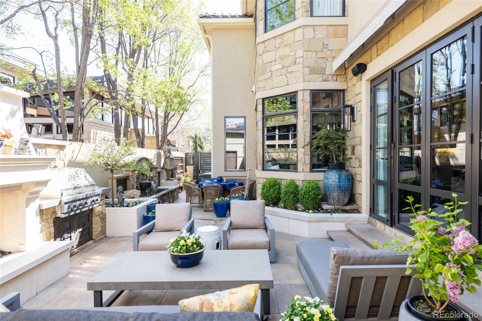 469 Cook Street Denver, CO 80206 - Photo 24 of 50 a view of a patio with couches table and chairs and potted plants