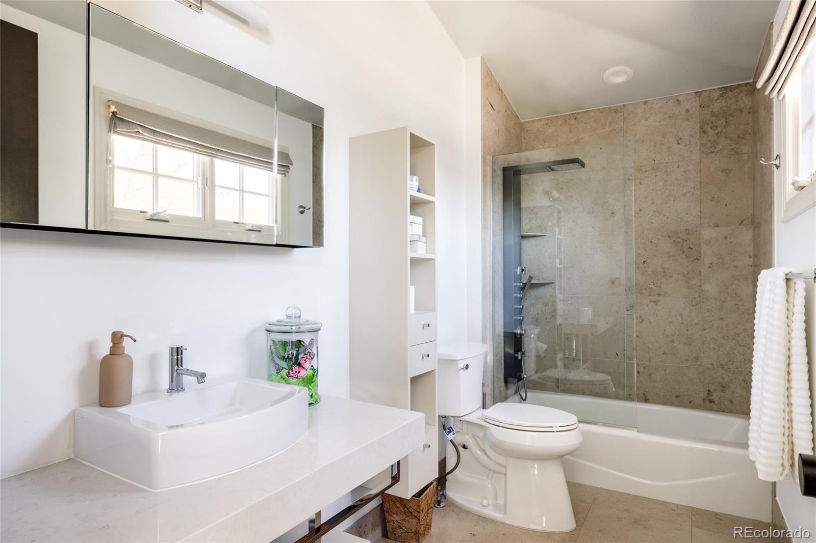 469 Cook Street Denver, CO 80206 - Photo 29 of 50 a bathroom with a sink toilet a mirror and shower