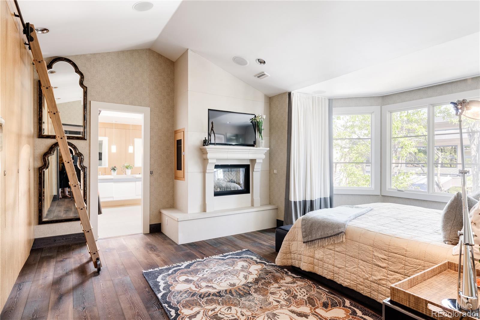 469 Cook Street Denver, CO 80206 - Photo 31 of 50 a bedroom with a bed and a flat screen tv