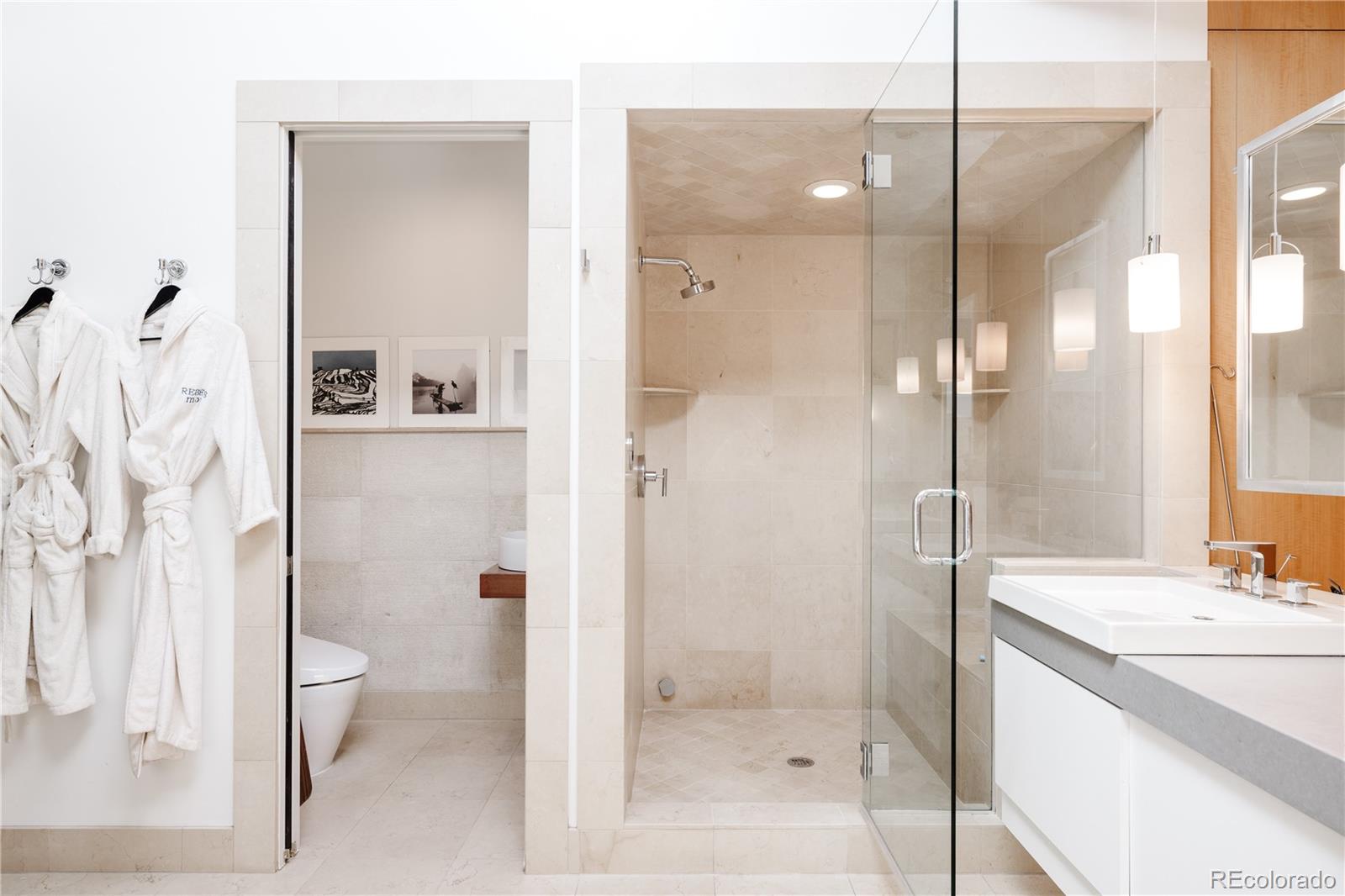 469 Cook Street Denver, CO 80206 - Photo 34 of 50 a bathroom with a shower sink vanity mirror and toilet