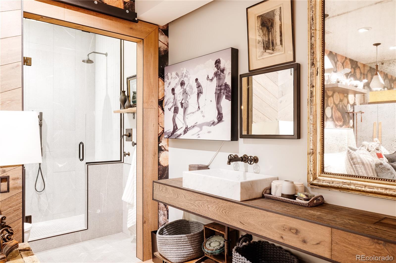 469 Cook Street Denver, CO 80206 - Photo 46 of 50 a bathroom with a granite countertop sink a mirror and shower
