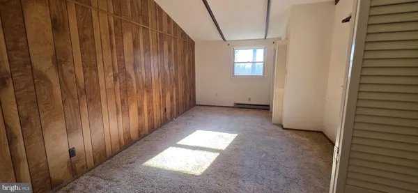 a white toilet sitting next to a bathroom sink and a window