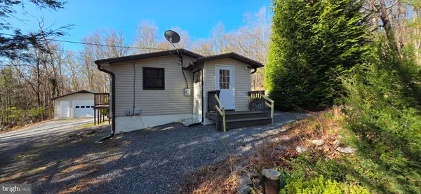 a view of a house with a yard and sitting area