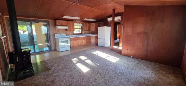 a view of a hallway with an empty room and windows