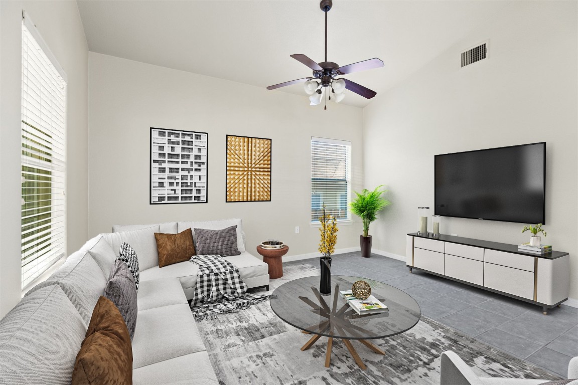 a living room with furniture a flat screen tv and a window