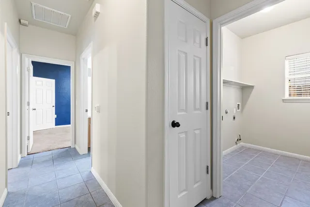 a view of a hallway with an entryway door