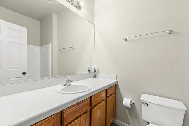 a bathroom with a sink toilet and vanity
