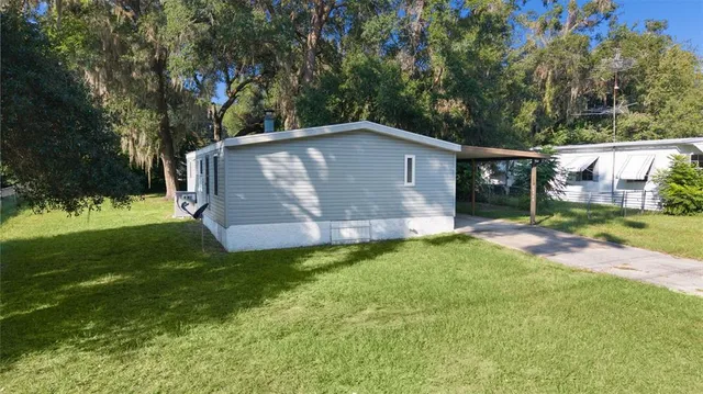 an aerial view of a house with outdoor space