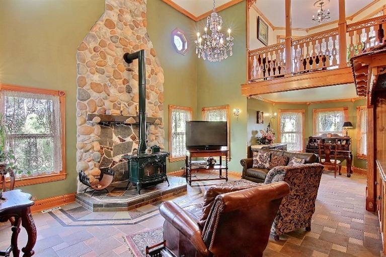 11906 Burr Street Crown Point, IN 46307 - Photo 6 of 10 a living room with furniture a flat screen tv and a floor to ceiling window
