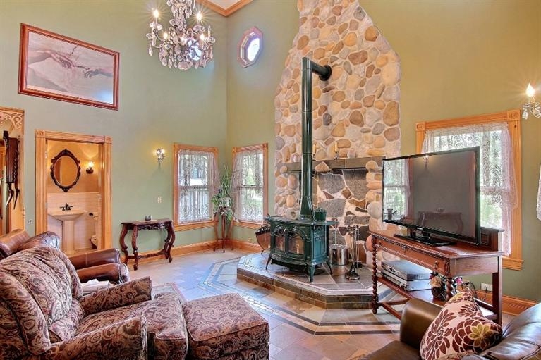 11906 Burr Street Crown Point, IN 46307 - Photo 8 of 10 a living room with furniture a flat screen tv and a fireplace