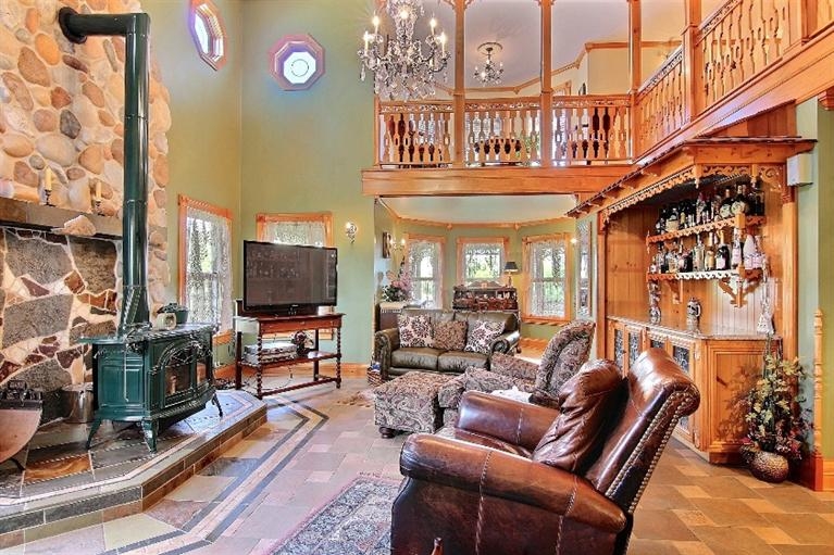 11906 Burr Street Crown Point, IN 46307 - Photo 9 of 10 a living room with furniture a flat screen tv and a floor to ceiling window