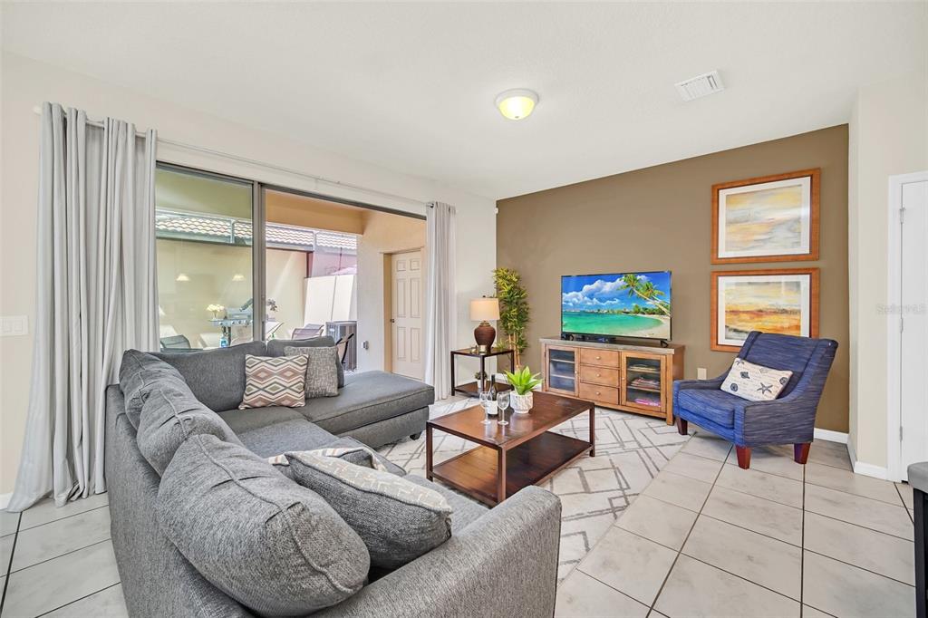 2070 Rome Drive Kissimmee, FL 34747 - Photo 15 of 57 a living room with furniture and a flat screen tv