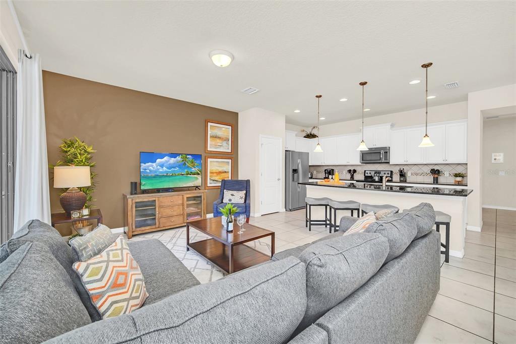 2070 Rome Drive Kissimmee, FL 34747 - Photo 18 of 57 a living room with furniture kitchen view and a large window