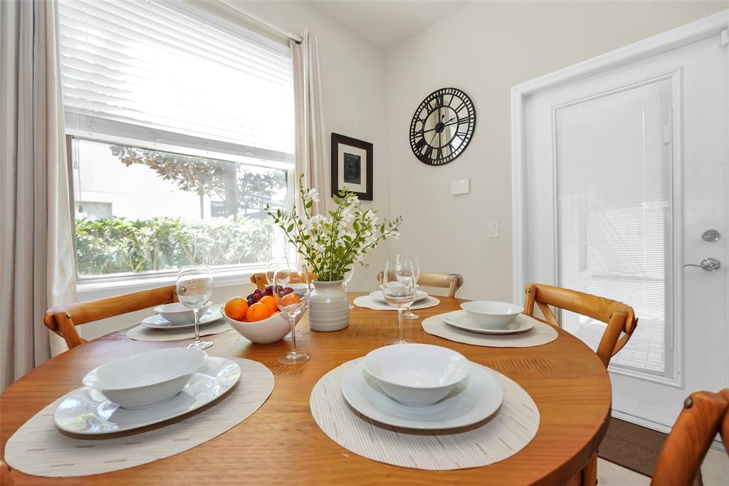 2070 Rome Drive Kissimmee, FL 34747 - Photo 20 of 57 a dining room with furniture a wooden floor and a chandelier