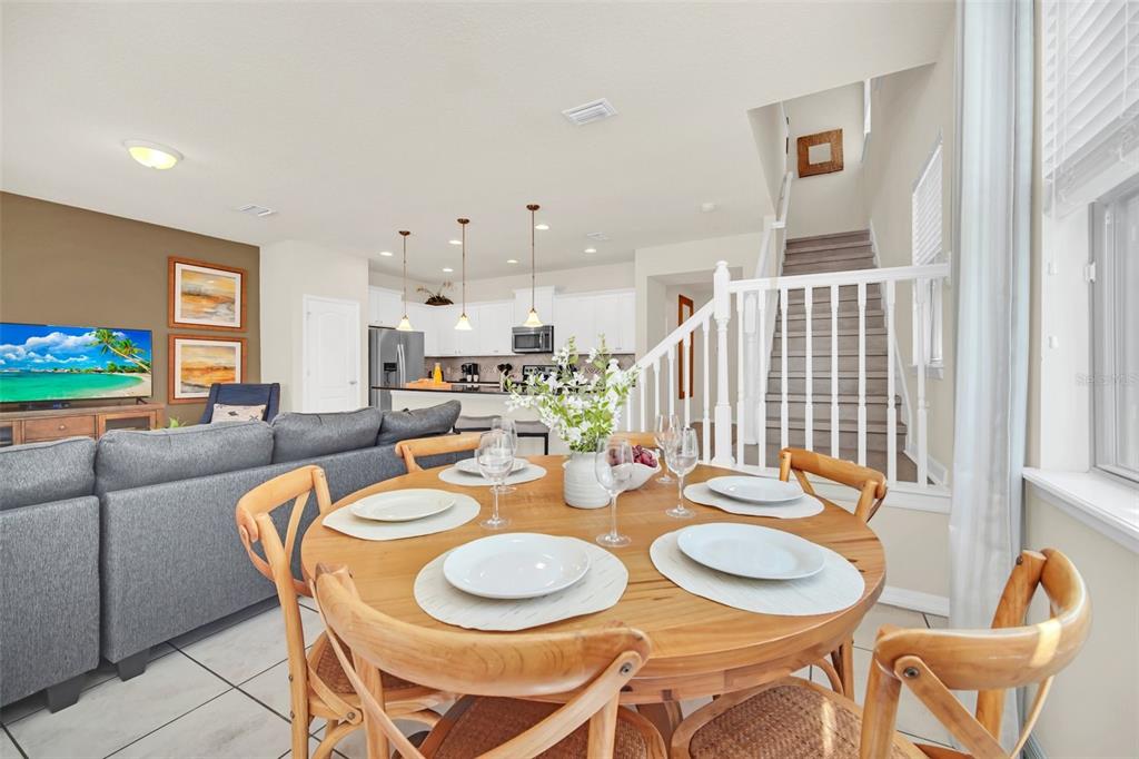 2070 Rome Drive Kissimmee, FL 34747 - Photo 22 of 57 a dining room with furniture and wooden floor