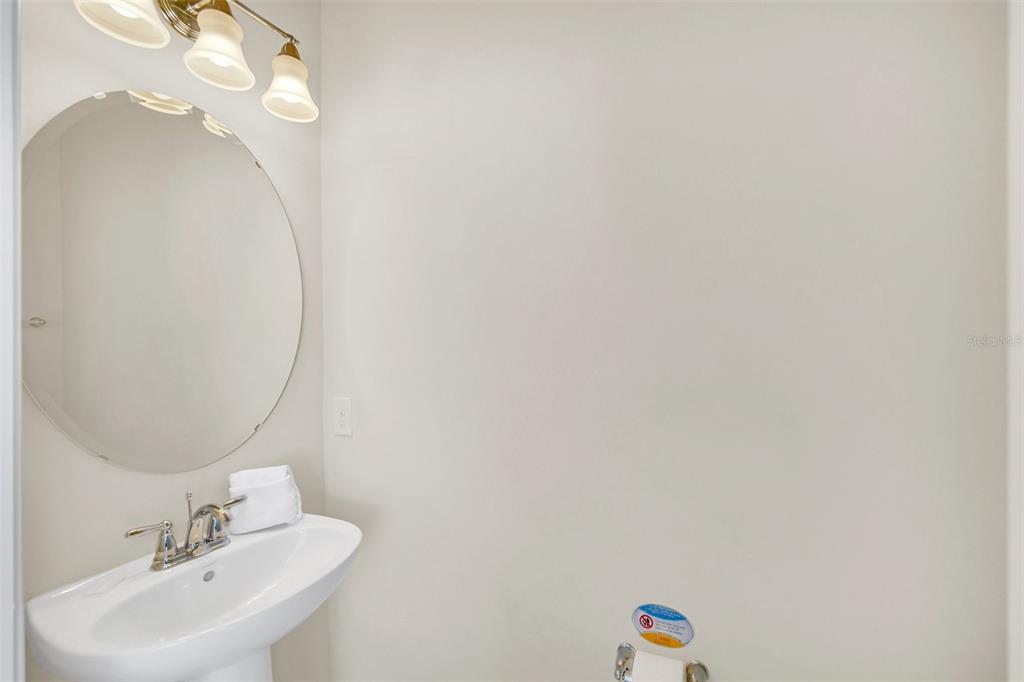 2070 Rome Drive Kissimmee, FL 34747 - Photo 25 of 57 a bathroom with a sink and a mirror