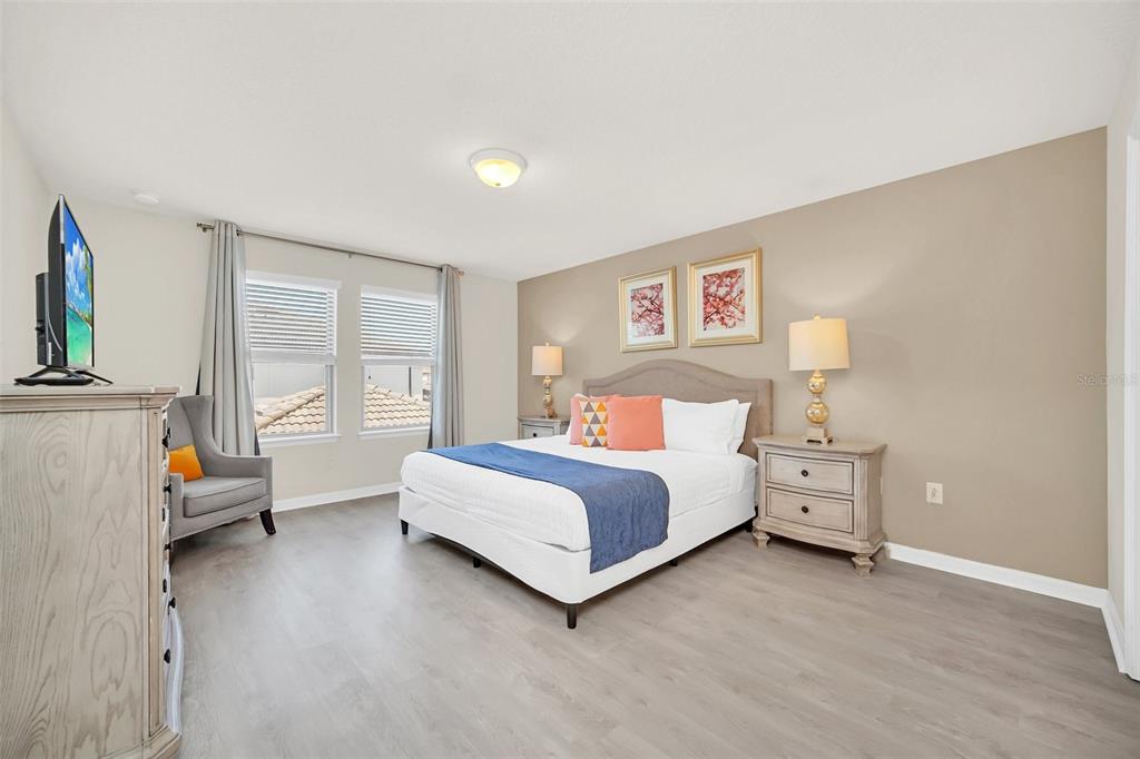 2070 Rome Drive Kissimmee, FL 34747 - Photo 30 of 57 a spacious bedroom with a bed and a couch