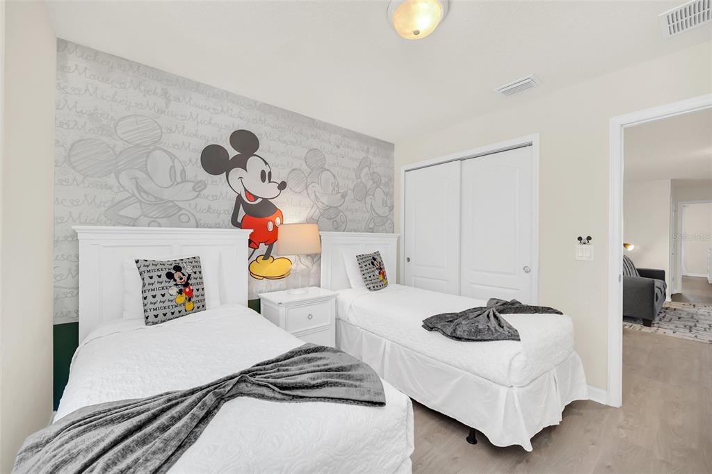 2070 Rome Drive Kissimmee, FL 34747 - Photo 3 of 57 a bedroom with a bed a couch and a chandelier