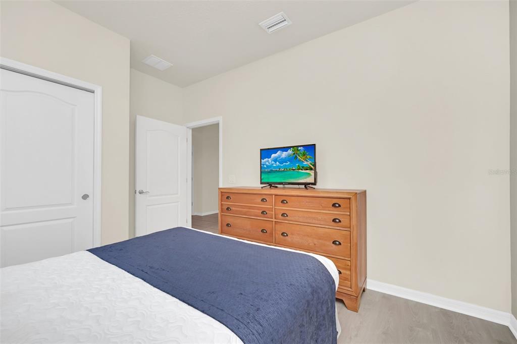 2070 Rome Drive Kissimmee, FL 34747 - Photo 37 of 57 a bedroom with a bed and a tv on the dresser