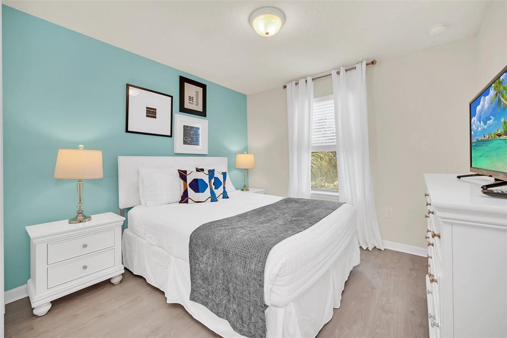 2070 Rome Drive Kissimmee, FL 34747 - Photo 39 of 57 a bedroom with a bed and a flat screen tv