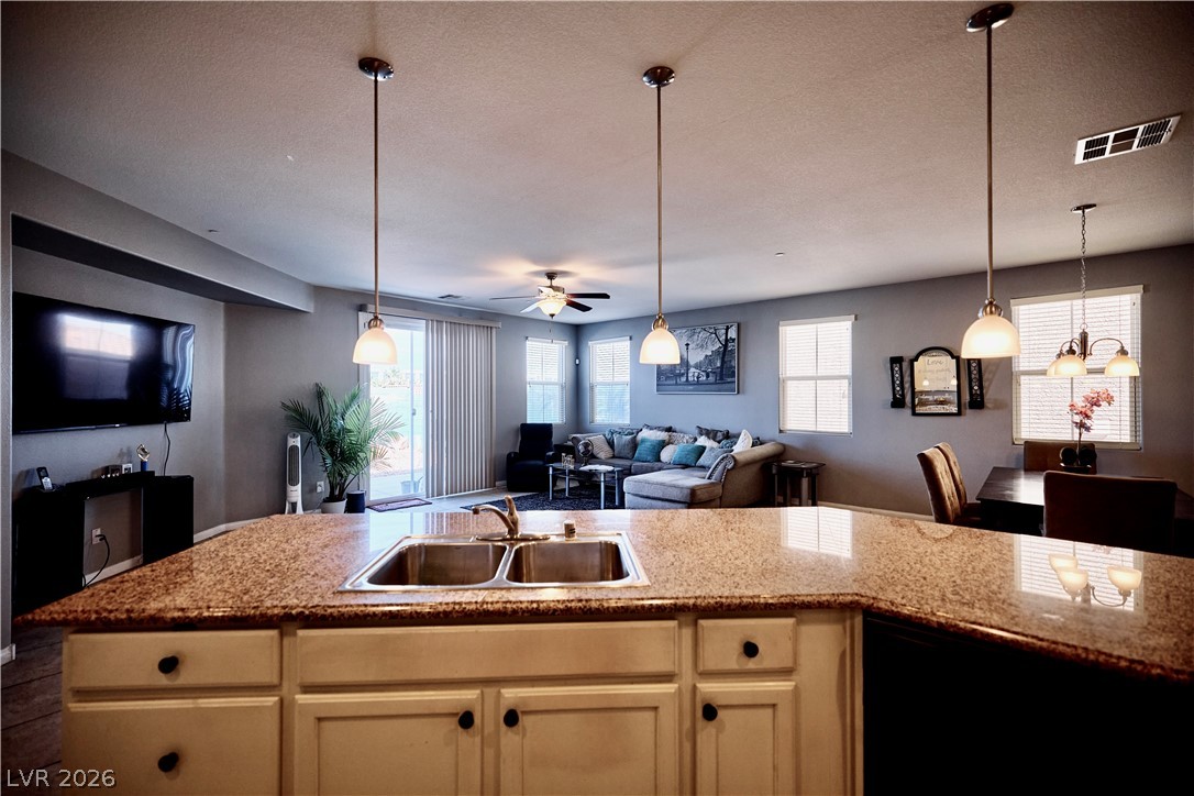 193 Tuscan Shadow Street Henderson, NV 89012 - Photo 11 of 27 This bright kitchen with a spacious island overlooks a comfortable living area, perfect for daily living and entertaining.