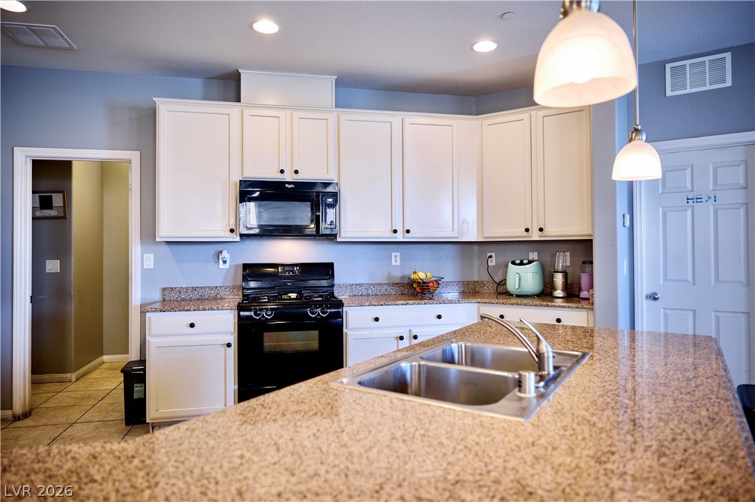 193 Tuscan Shadow Street Henderson, NV 89012 - Photo 13 of 27 This functional kitchen features ample counter space and convenient appliances, perfect for daily living.