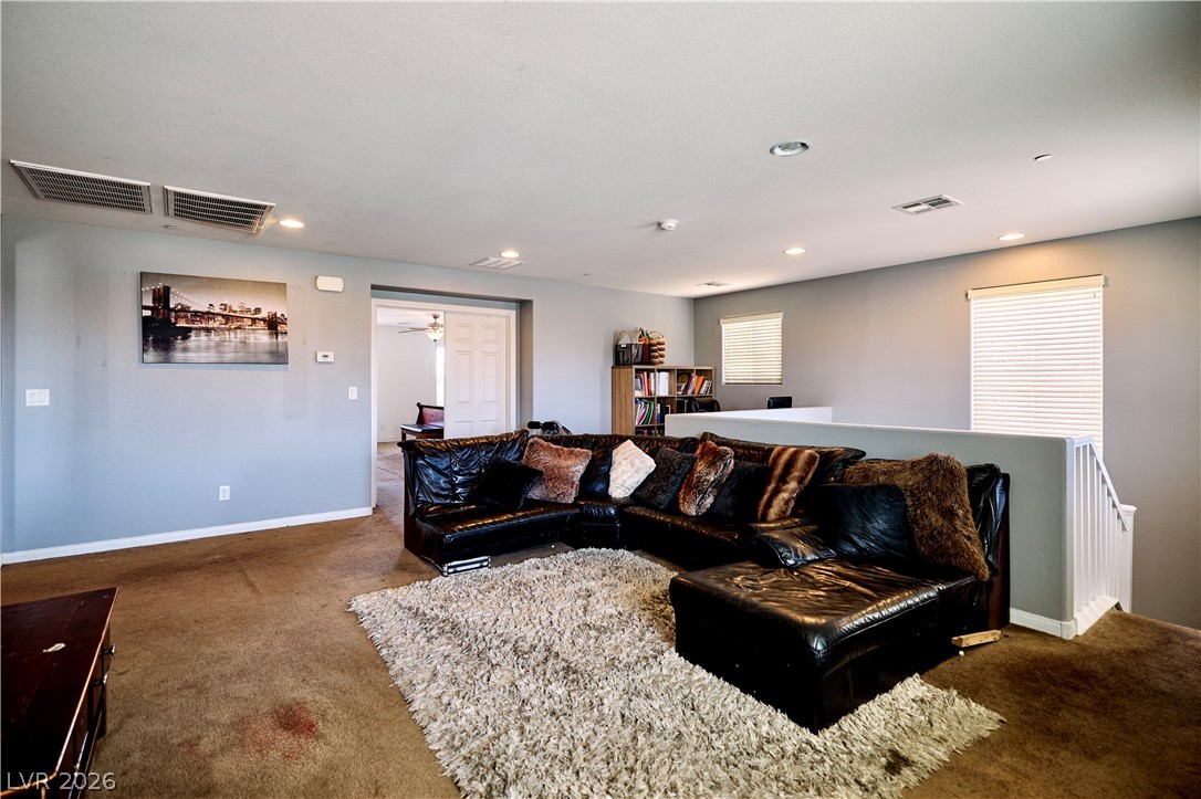 193 Tuscan Shadow Street Henderson, NV 89012 - Photo 18 of 27 This versatile upstairs loft area offers comfortable living, perfect for relaxation or a home office setup.