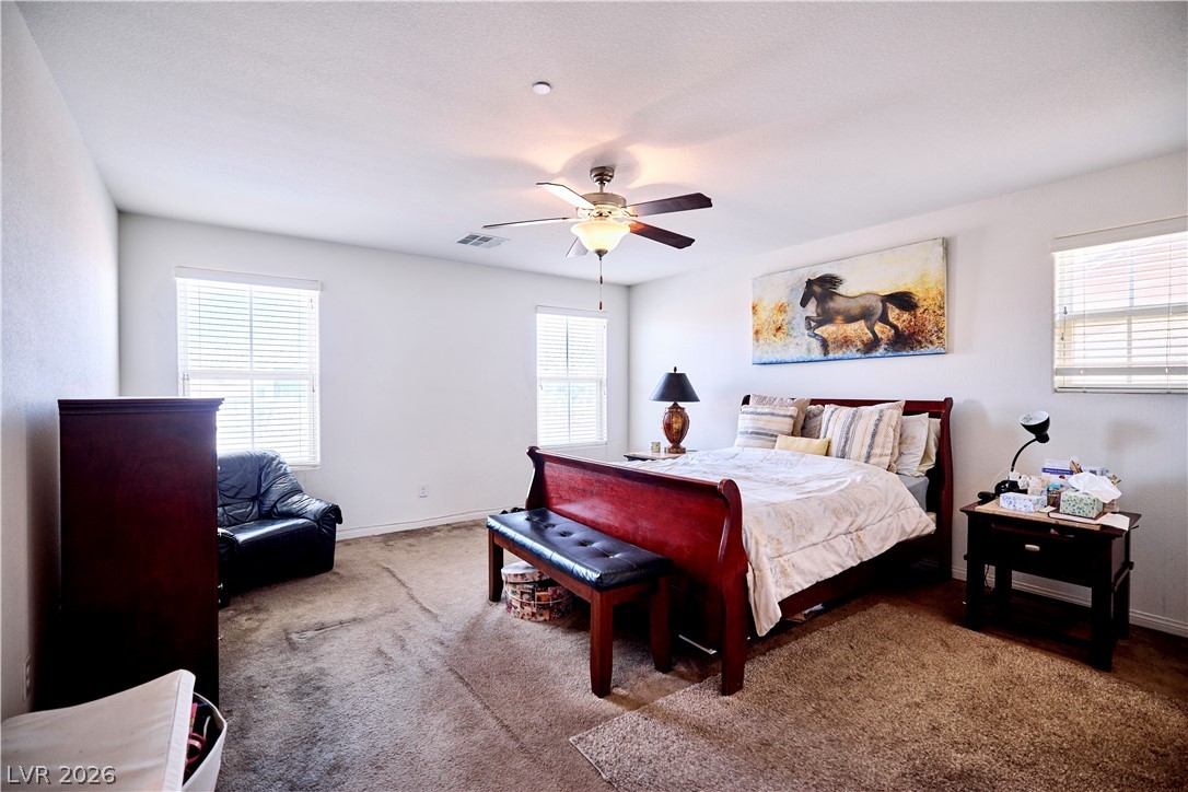 193 Tuscan Shadow Street Henderson, NV 89012 - Photo 19 of 27 This upstairs primary bedroom provides a comfortable retreat with ample natural light.