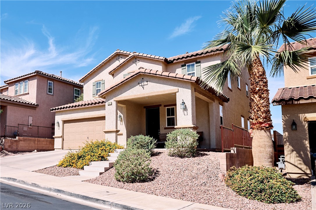 193 Tuscan Shadow Street Henderson, NV 89012 - Photo 2 of 27 This appealing residence features a two-story design with a front-facing garage and welcoming covered entry.