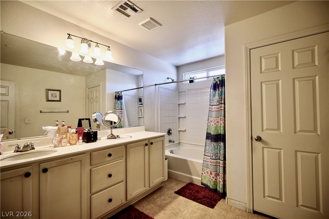 193 Tuscan Shadow Street Henderson, NV 89012 - Photo 21 of 27 This clean and inviting ensuite bathroom offers functional design and practical comforts for daily routines.