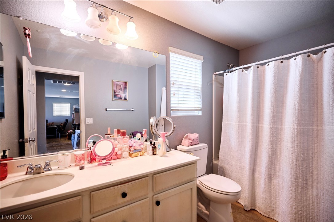 193 Tuscan Shadow Street Henderson, NV 89012 - Photo 25 of 27 This upstairs guest bathroom features a functional vanity, toilet, and shower, offering everyday comfort and convenience.