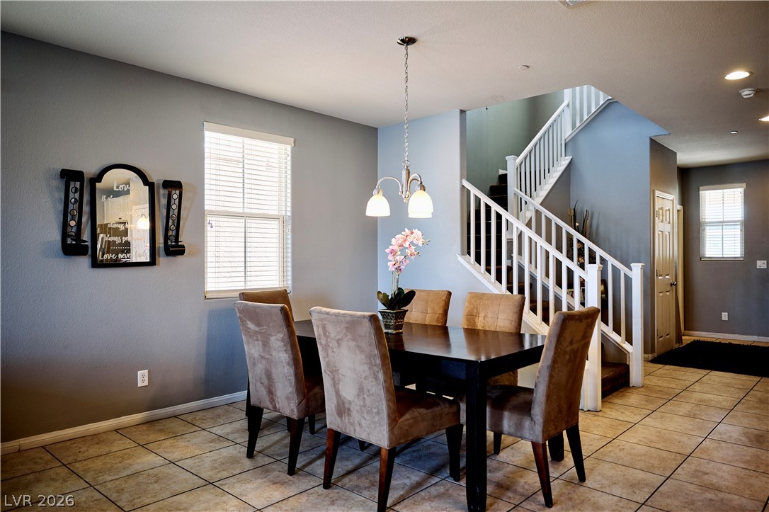 193 Tuscan Shadow Street Henderson, NV 89012 - Photo 8 of 27 This dining area showcases elegant flooring and an inviting staircase, perfect for entertaining.