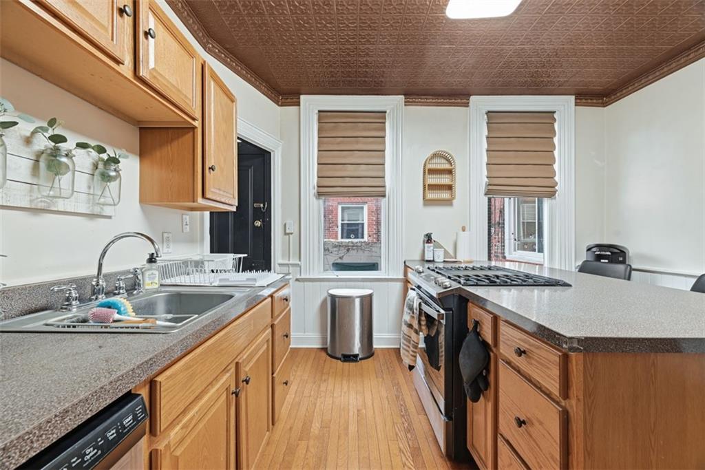 110 South 13th Street Pittsburgh, PA 15203 - Photo 12 of 36 a kitchen with stainless steel appliances granite countertop a sink stove and cabinets