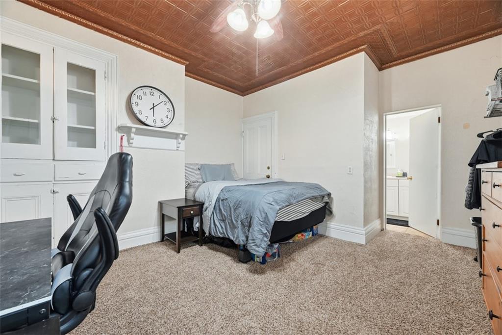 110 South 13th Street Pittsburgh, PA 15203 - Photo 17 of 36 a bedroom with a bed a large mirror and a desk