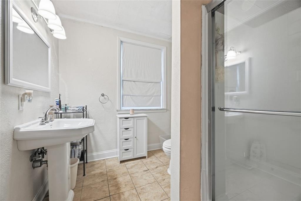110 South 13th Street Pittsburgh, PA 15203 - Photo 24 of 36 a bathroom with a sink mirror and a shower