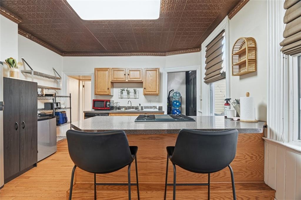 110 South 13th Street Pittsburgh, PA 15203 - Photo 10 of 36 a kitchen with stainless steel appliances granite countertop a kitchen island a stove a dining table and chairs