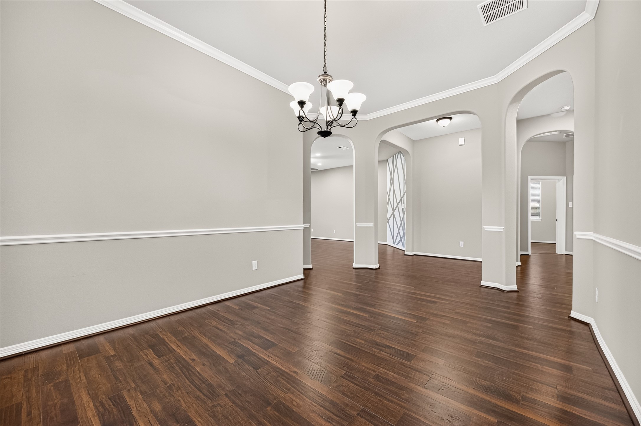 4314 Kent Ranch Court Katy, TX 77494 - Photo 13 of 49 Formal dining room with arched openings to the entry and living areas.