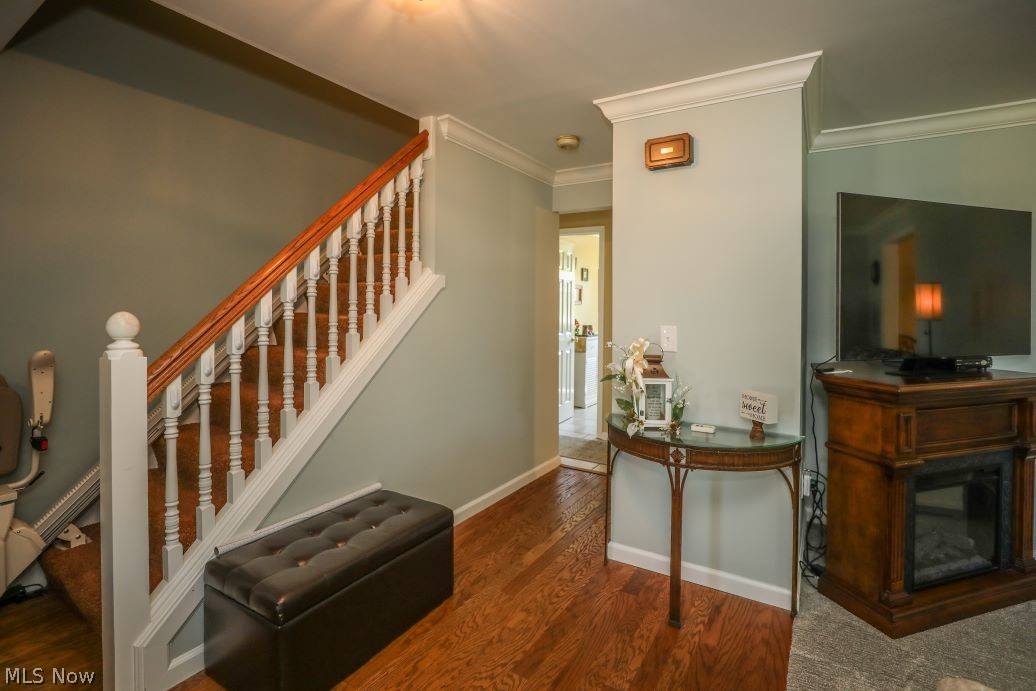 3022 Sandy Lake Road Ravenna, OH 44266 - Photo 16 of 41 Staircase with ornamental molding and dark wood-type flooring