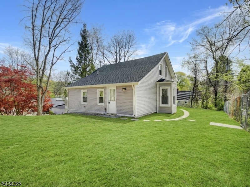 4 Emmans Road Ledgewood, NJ 07852 - Photo 1 of 25 a house that is sitting in the grass with tress in the background