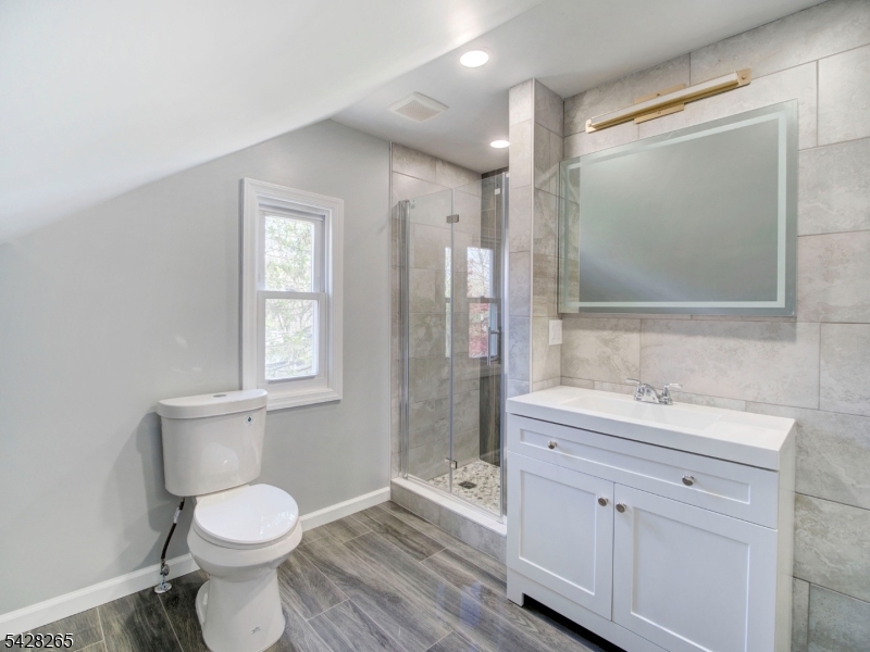 4 Emmans Road Ledgewood, NJ 07852 - Photo 19 of 25 a bathroom with a toilet sink a shower and a mirror