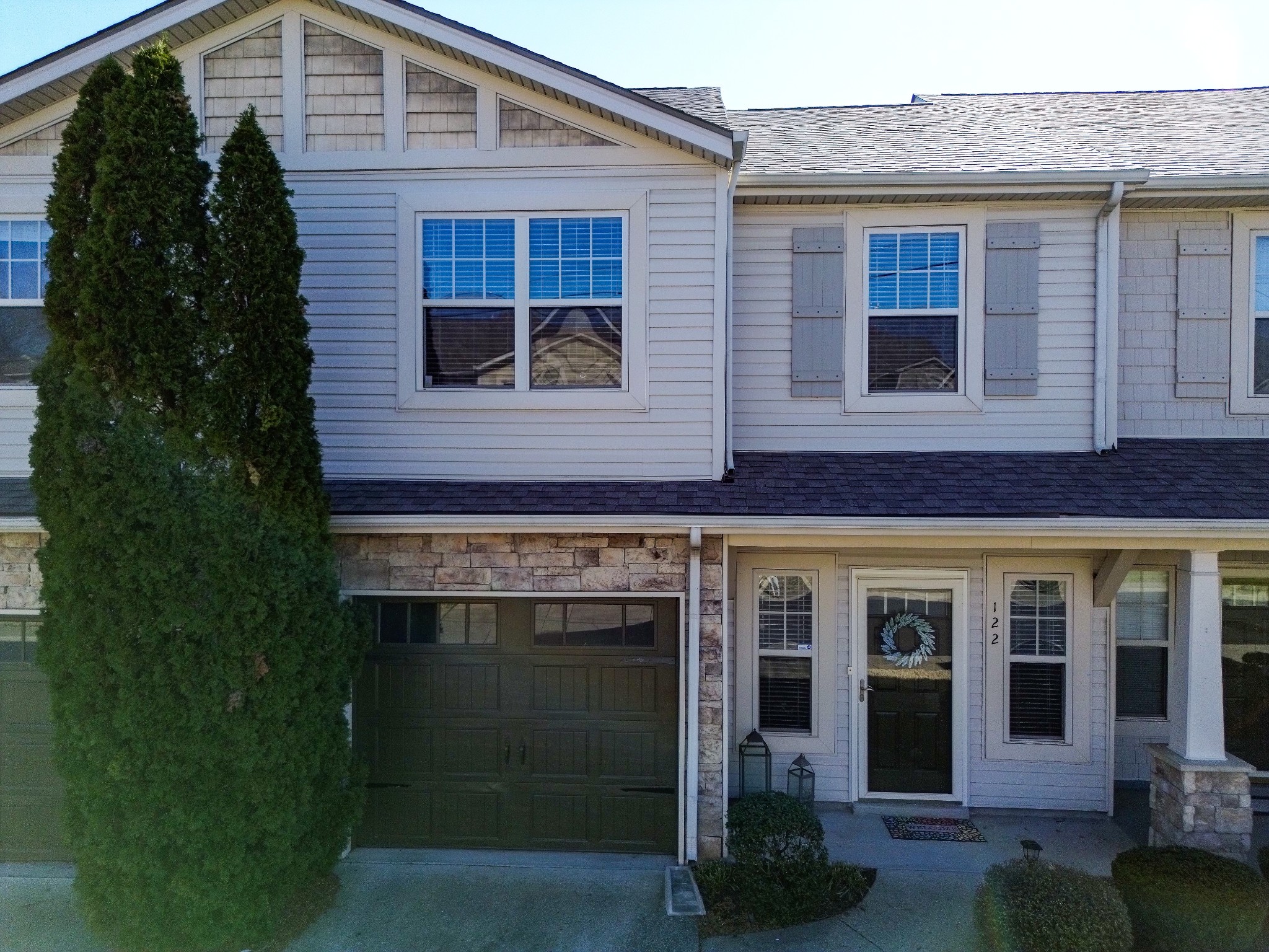 735 Tulip Grove Road, Unit 122 Hermitage, TN 37076 - Photo 1 of 39 a view of a brick house with plants and large windows