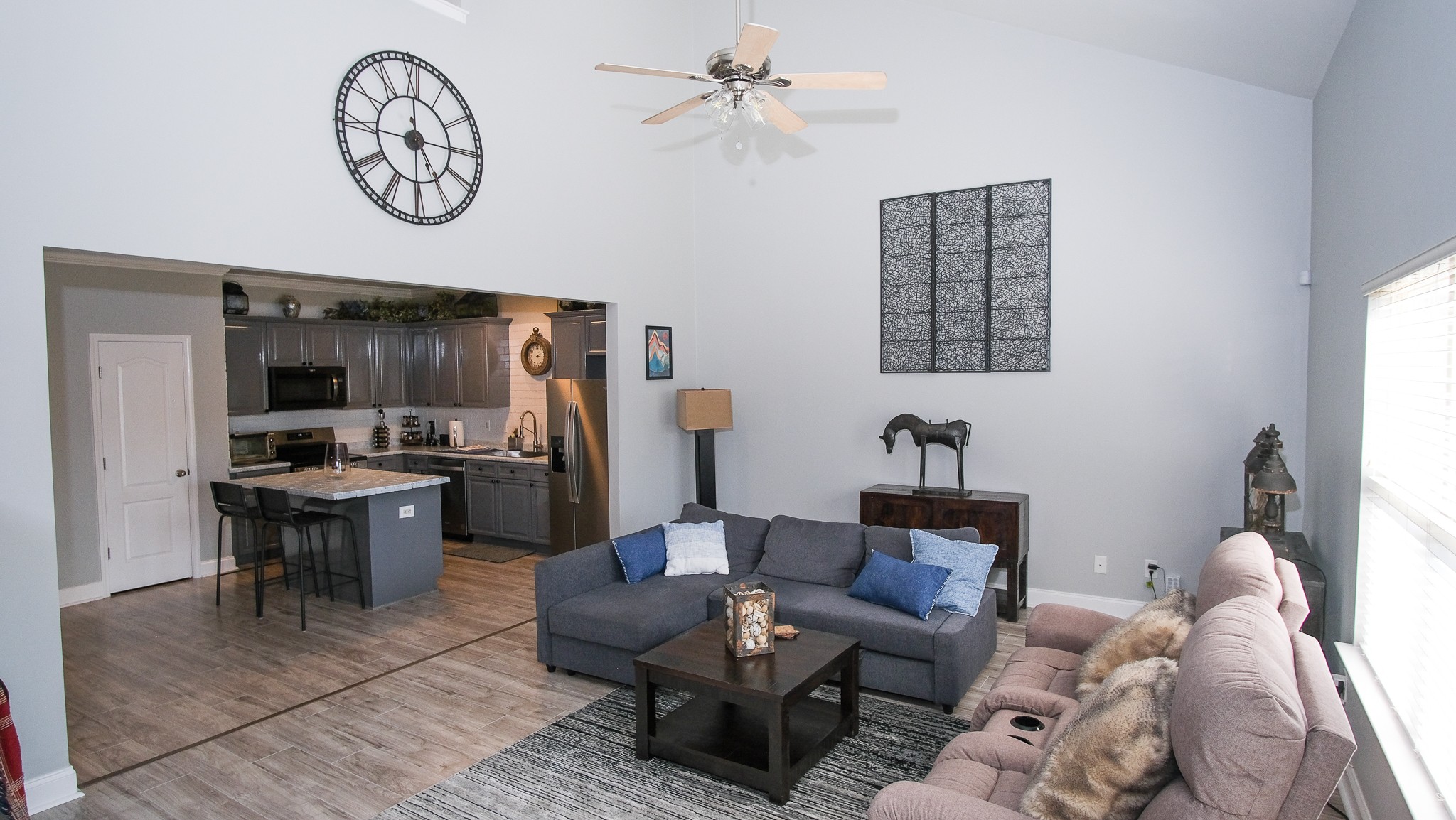 735 Tulip Grove Road, Unit 122 Hermitage, TN 37076 - Photo 15 of 39 a living room with furniture a flat screen tv and a wall clock