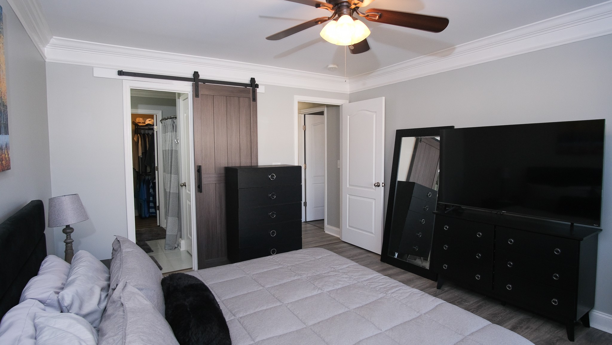 735 Tulip Grove Road, Unit 122 Hermitage, TN 37076 - Photo 27 of 39 a bedroom with a bed and a flat tv screen on dresser