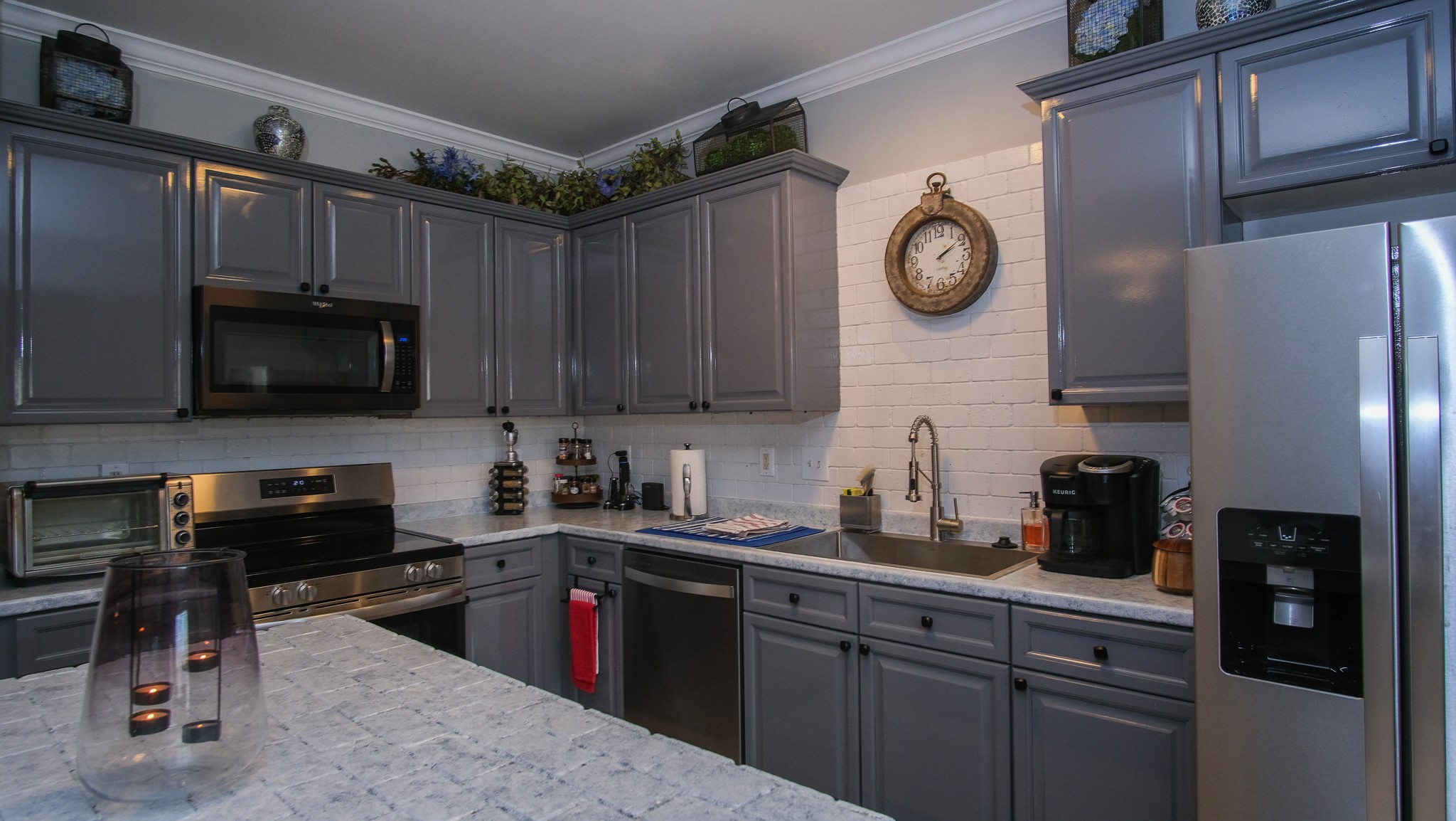 735 Tulip Grove Road, Unit 122 Hermitage, TN 37076 - Photo 9 of 39 a kitchen with stainless steel appliances granite countertop a refrigerator a stove a sink dishwasher and white cabinets with wooden floor