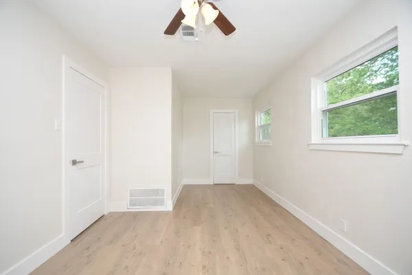 wooden floor in an empty room with a window