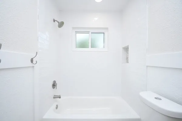 a bathroom with a bathtub and toilet
